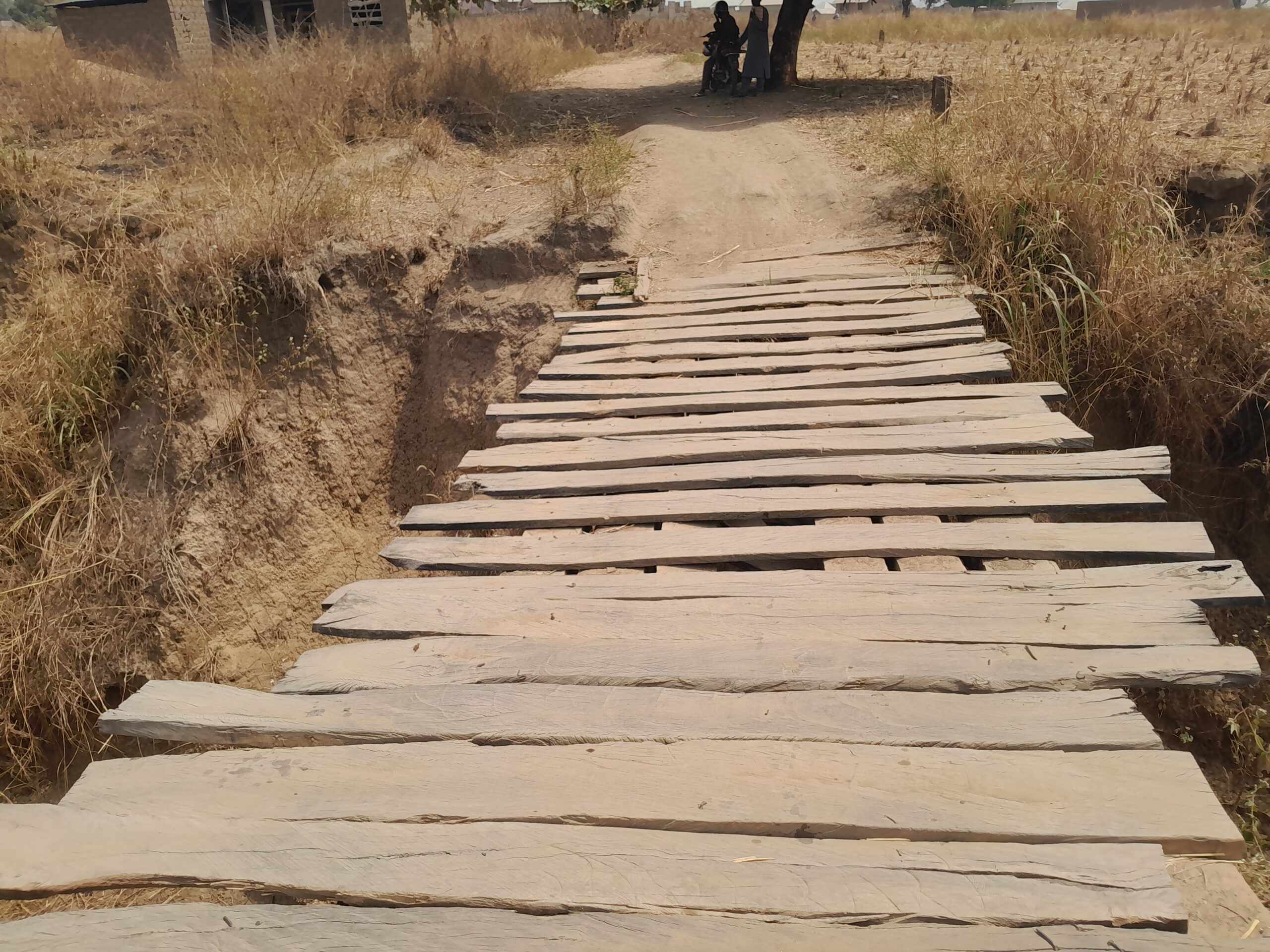 The road leading to Garin Buba suffers from a collapsing bridge, but the residents collaborated to build a wooden bridge. Photo Credit Yahuza Bawage Prime Progress.