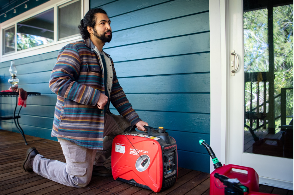 Nikola Alexandre fires up a generator at Shelterwood, a queer and trans people of color land stewardship project in Cazadero, California. Photo credit: Brooke Anderson