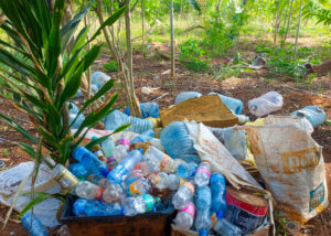 Plastic bottles used to make plastic flowers lay on the ground, ready for sorting in Kilifi, Kenya.