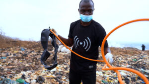 Methane_Munching_Microbes_5 Chidozie Okafor wrangling plastic tubing while collecting methane samples at a landfill site in Anambra State.