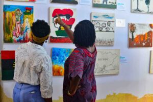 Chief Heritage Officer, Dr Ijeoma Onyejekwe, (left) and Program Officer, Centre For Memories, Ifeoma Nnamani (right) closely looking at the Biafra Legacy Exhibition at the Centre For Memories in Enugu, Nigeria on October, 22, 2025. Photo: Sam-Eze Chidera Ifeakanwa, bird story agency