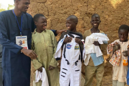 These children are smiling after receiving the clothes that will keep them warm in Harmattan. Photo Credit GCF