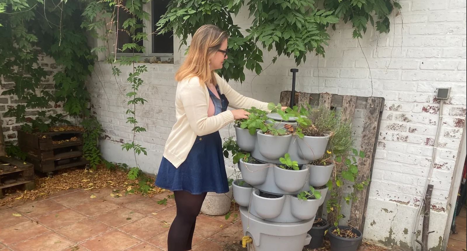 Amber Ogborn with one of her home composting systems. Photo credit: Joseph Winters for Grist