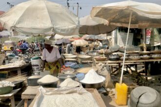 A woman selling her ware in the Ajata market. Photo Credit: Rejoice Taddy/ Prime progress