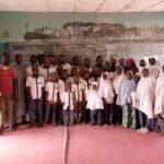 Ibrahim Tukur, other teachers, and the pupils gathered inside a larger classroom. Photo credit: Ibrahim Tukur.