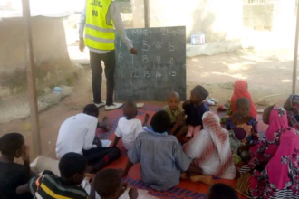 The Fulani children pay attention to the teacher who teaches them numbers. Photo credit: Fulani Care and Support Foundation.