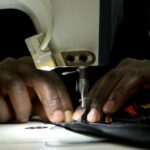 A tailor making an ankara design. Photo credit: Bird story agency