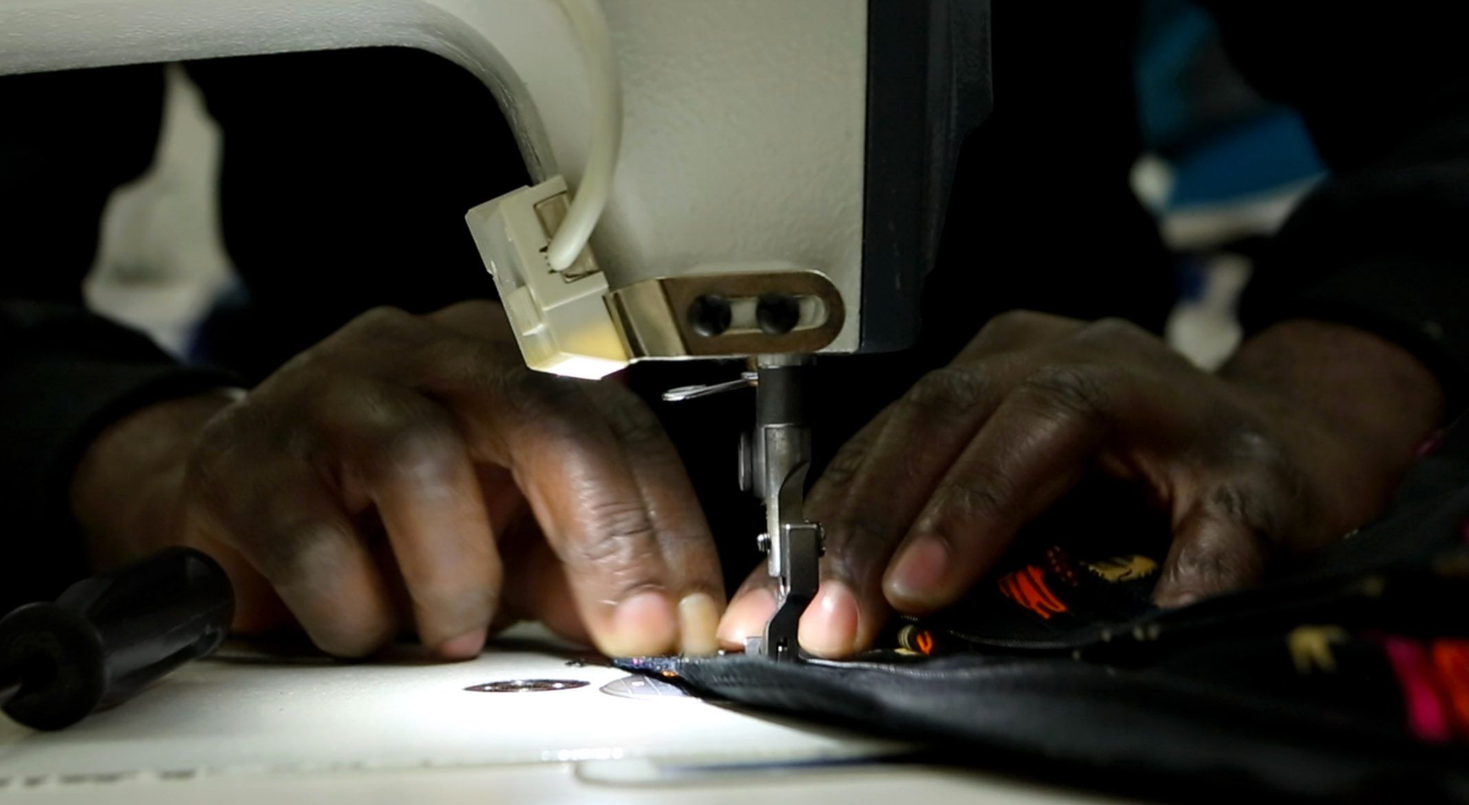 A tailor making an ankara design. Photo credit: Bird story agency