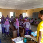 A tutor teaching pupils with hearing impairments at Baboko FOMWAN School.