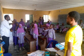 A tutor teaching pupils with hearing impairments at Baboko FOMWAN School.