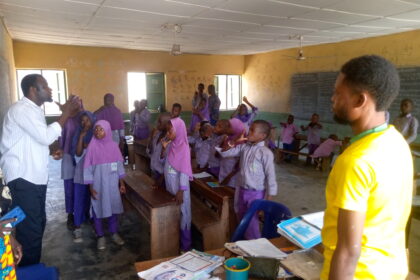 A tutor teaching pupils with hearing impairments at Baboko FOMWAN School.