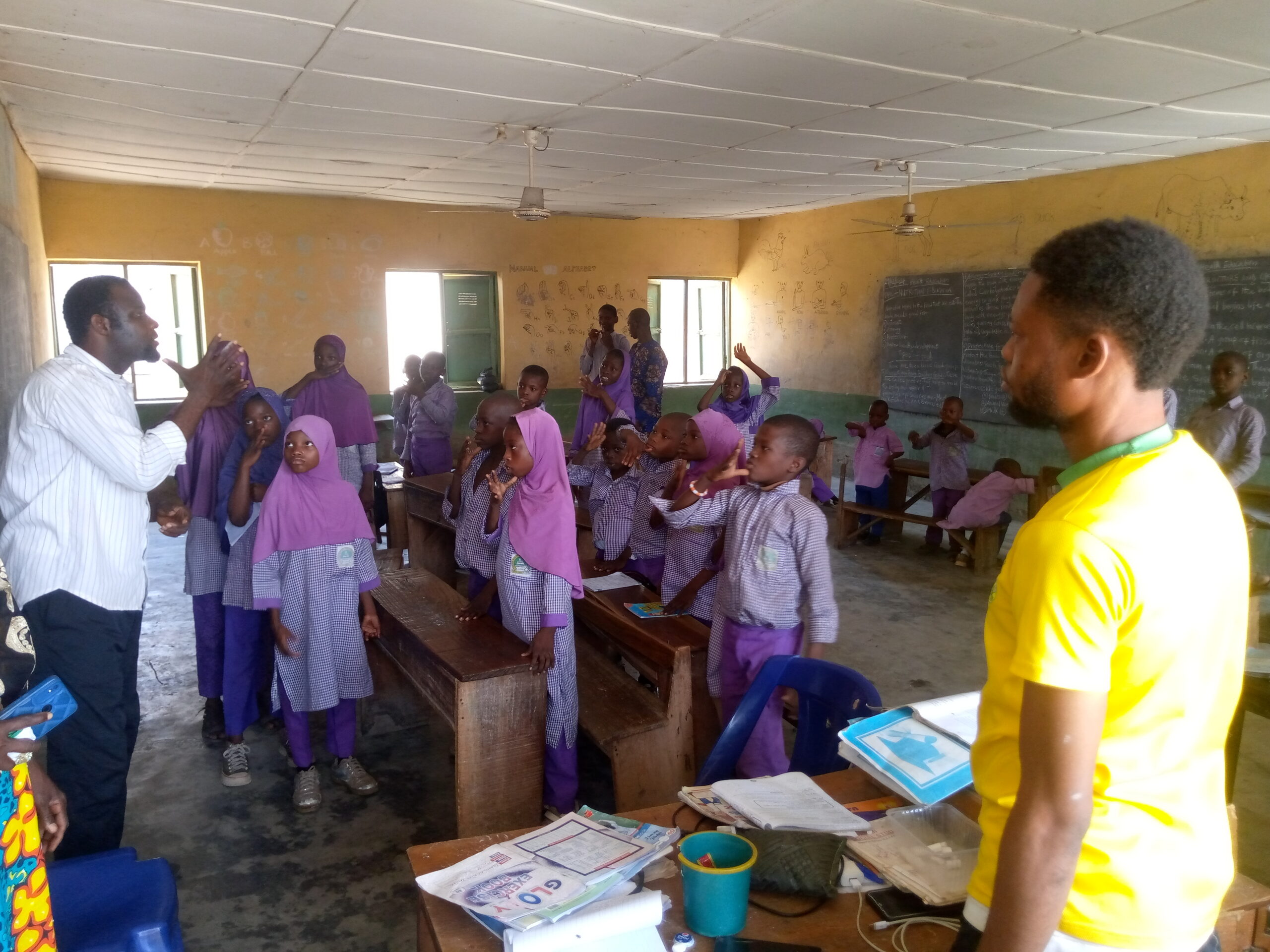 A tutor teaching pupils with hearing impairments at Baboko FOMWAN School.