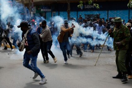 Kenyan police lobby tear gas cannisters at protesters. Photo credit: BusinessDay NG