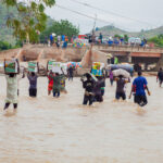 Young people struggling to cross luggage at the Shuwa River following the collapse of the bridge. Photo Ahmed Abubakar Bature.