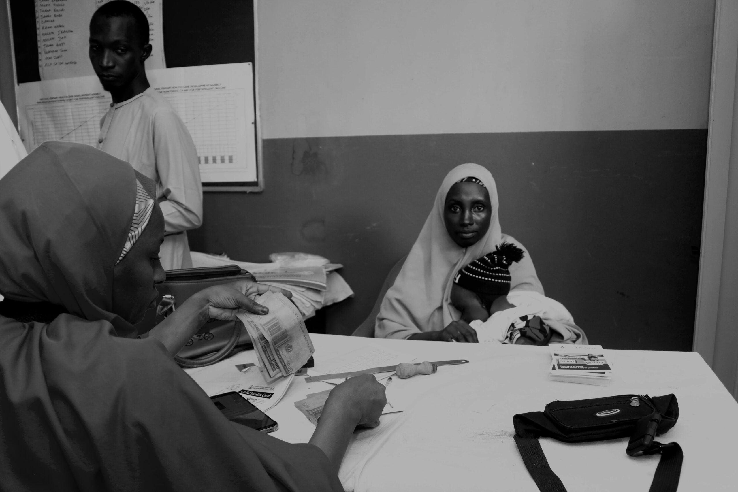 After vaccinating her child, Aishatu Adamu waits for her cash: Photo Credit: Ogar Monday