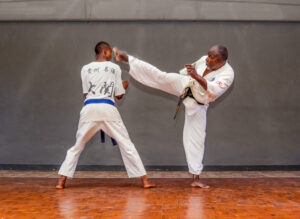 Master Charles(right) demonstrating the Jodan Mawashi geri with student Blessed Paidamoyo (left) in his dojo at the Courtauld Theatre in Mutare, Zimbabwe. Photo: Jacqueline Muchazoreka. Bird story agency