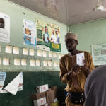 Ibrahim Dauda, a caregiver with NI-ABAE showing the women how the immunization process works. Photo Credit: Ogar Monday/PrimeProgress