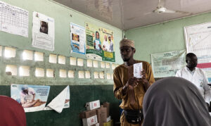 Ibrahim Dauda, a caregiver with NI-ABAE showing the women how the immunization process works. Photo Credit: Ogar Monday/PrimeProgress