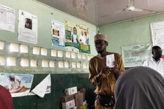 Ibrahim Dauda, a caregiver with NI-ABAE showing the women how the immunization process works. Photo Credit: Ogar Monday/PrimeProgress