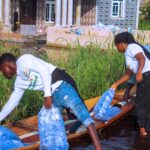 Enibo Albert and volunteers distributing bags of drinking water to residents of Agudama in Bayelsa