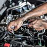 Auto mechanic working and repair on car engine in mechanics gara