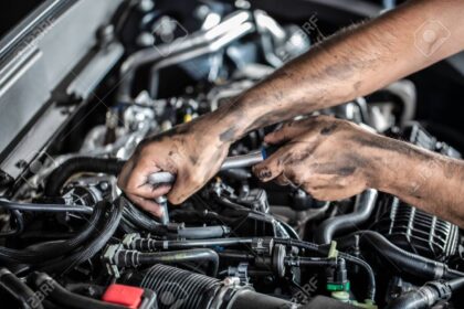 Auto mechanic working and repair on car engine in mechanics gara
