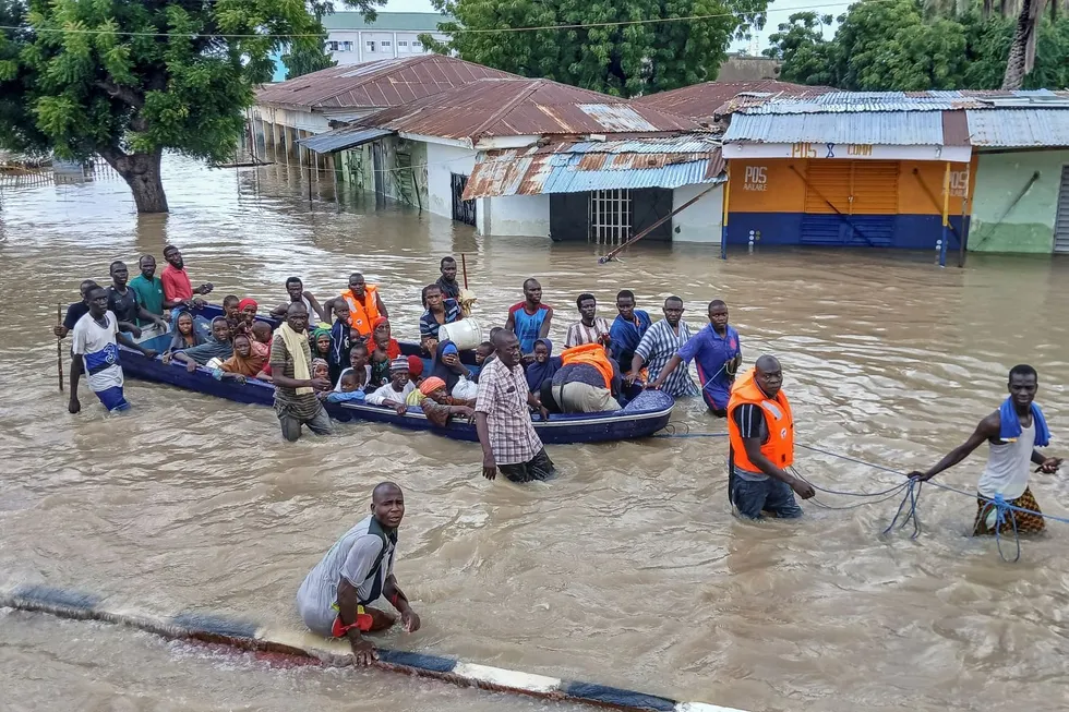 people affected by floods are escorted through flood water on a military boat in maiduguri on september 12 2024 severe floodin