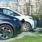 two charging electric cars charge station city min (1) (1)