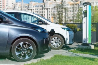 two charging electric cars charge station city min (1) (1)