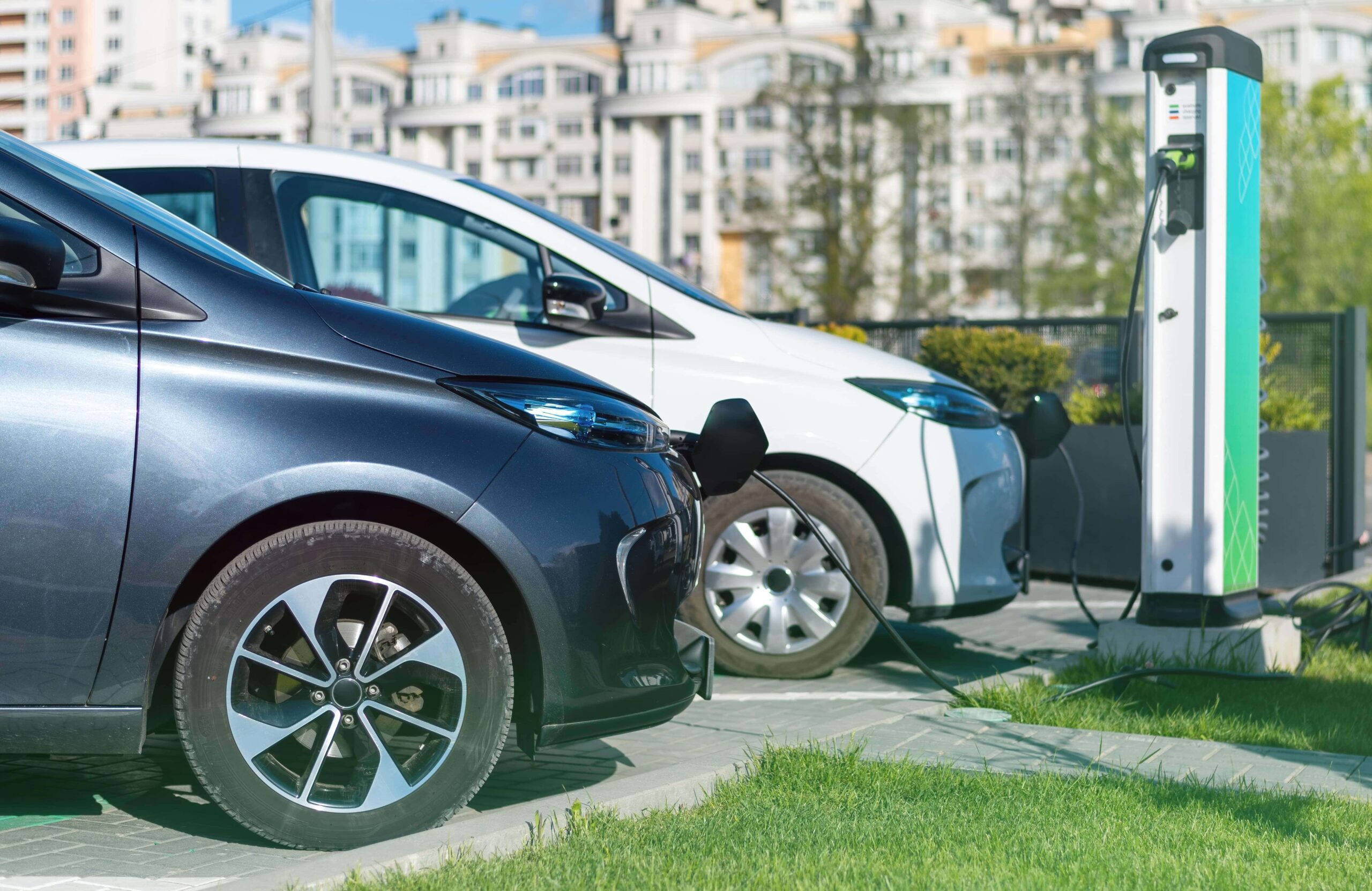 two charging electric cars charge station city min (1) (1)