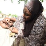 A health official immunises a child against diphtheria in Kano. Credit: Pius Utomi/Getty Images