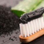 Charcoal toothpaste on a brush. Credit: Sourced from web