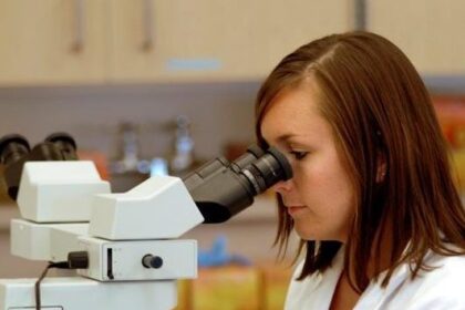 A research scientist looking into a microscope. Credit: Autism Science Foundation