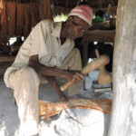 This is a photo of John Mukopa pounding bark in his workshop, used to illustrate the material knowledge program. Credit: EMKP