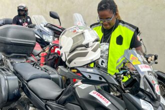 Bamba Édith Christine, President of the National Federation of Motorcycle Clubs and Related Organizations of Ivory Coast, preparing for a motorcycle race in Abidjan-Cocody, Credit: bird story agency