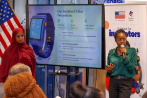 Pregnancy rist warning. Photo credit: Medibora team members Jael Wainaina (holding the microphone) and Fardosa Mohamed make presentation about their project during the hackathon's awarding ceremony. Photo courtesy: Medibora