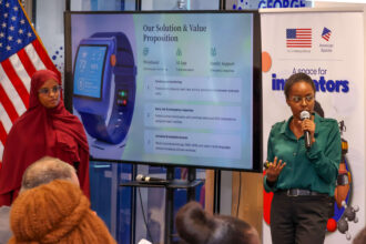 Pregnancy rist warning. Photo credit: Medibora team members Jael Wainaina (holding the microphone) and Fardosa Mohamed make presentation about their project during the hackathon's awarding ceremony. Photo courtesy: Medibora