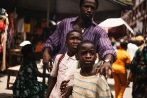 A still from My Father’s Shadow showing Ṣọpẹ́ Dìrísù as Folarin the father of Chibuike Marvellous Egbo and Godwin Egbo. Photo courtesy: MUBI.